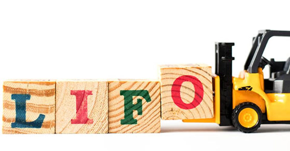 Toy forklift hold letter block o to complete word LIFO (Abbreviation of last in first out) on white background