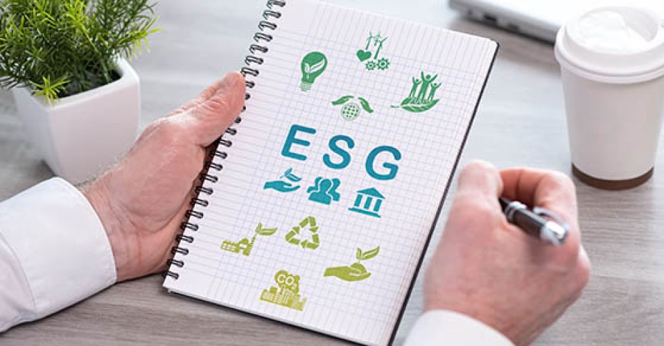Hand holding a notepad with esg concept